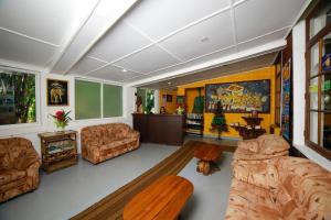 a living room with couches and a table at Jays Holiday Resort in Habarana