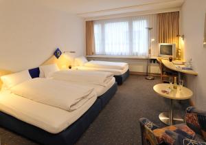 Postel nebo postele na pokoji v ubytování Hotel Blumenstein Self-Check In