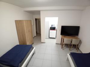 a room with two beds and a television in it at Center Apart Hannover in Hannover
