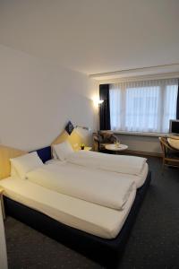 Postel nebo postele na pokoji v ubytování Hotel Blumenstein Self-Check In