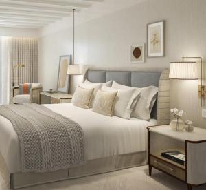 a bedroom with a large white bed and a table at Amadria Park Grand Hotel 4 Opatijska Cvijeta in Opatija