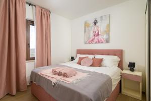 a bedroom with a bed with pink towels on it at Villa Brajde by IstriaLux in Gajana +33 photos