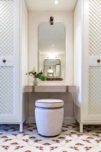 a bathroom with a white toilet and a mirror at Amadria Park Grand Hotel 4 Opatijska Cvijeta in Opatija +24 photos