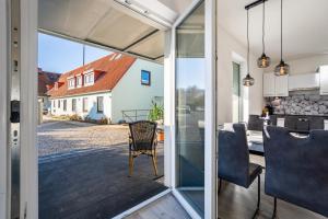 a kitchen and dining room with a view of a house at Ostseerauschen in Hohwacht