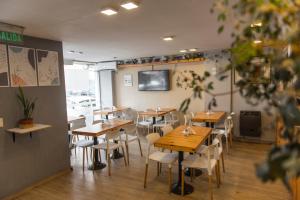 a dining room with wooden tables and chairs at Novum Suites in Córdoba
