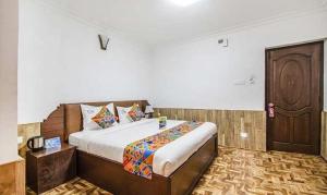 Postel nebo postele na pokoji v ubytování Kevins Bearshola Residency