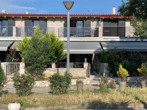 a building with a street light in front of it at Luxury Maisonette Blue Stone in Hanioti