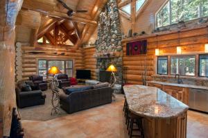 a living room in a log cabin with wooden walls at El Capitan in Wawona