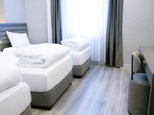 Postel nebo postele na pokoji v ubytování Optimal Hotel