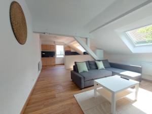 a living room with a couch and a table at Cosy 4 - Audincourt centre in Audincourt
