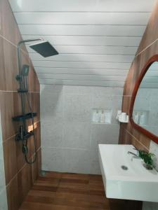 a bathroom with a sink and a mirror at Tria Maria Cottage in Ngurblut +75 photos