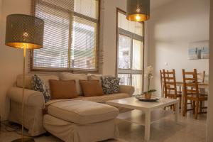 a living room with a couch and a table at VV Saso Beach Puerto Naos in Puerto Naos