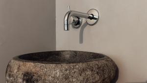 a bathroom sink with a faucet on a wall at APARTMENTS mit PRIVAT SPA - Haus LuKa in Fischbach