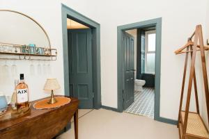 a bathroom with green doors and a table with a lamp at Torr House Hotel in Dumfries +62 photos