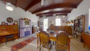 a dining room with a wooden table and chairs at Tradouw Guesthouse in Barrydale