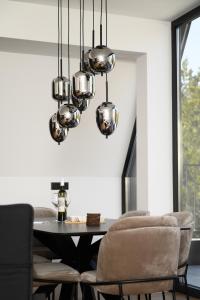 a dining room with a table and chairs at Woodlander Mountain House Blidinje in Blidinje