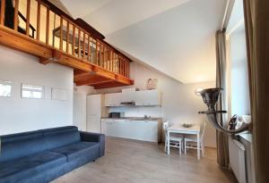 a living room with a blue couch and a kitchen at Apartments Katrca Ljubljana in Ljubljana