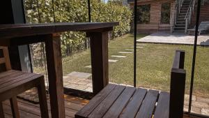 a wooden bench on a deck with a view of a yard at APARTMENTS mit PRIVAT SPA - Haus LuKa in Fischbach