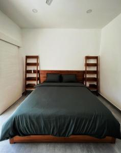 a bedroom with a large bed with two wooden shelves at Villa Aora Bingin Large 4 Bedroom Villa in Uluwatu +23 photos