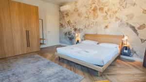 a bedroom with a bed and a painting on the wall at The Roman Villa View - Italian Homing in Desenzano del Garda
