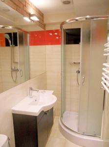 a bathroom with a sink and a shower at Hotel Park in Inowrocław +39 photos