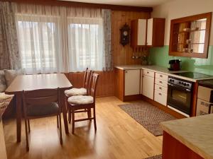 a kitchen with a table and chairs and a dining room at Ferienhaus Freiraum in Niederwölz