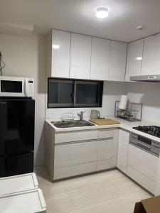 Una cocina o cocineta en Mark的足立民宿