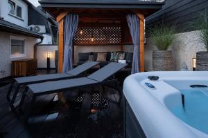 a balcony with a tub and a table and a bathtub at Niederhut-Residenz in Bad Neuenahr-Ahrweiler
