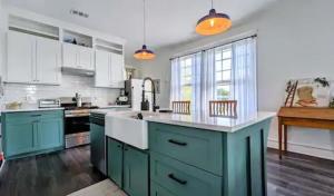 a kitchen with blue cabinets and white appliances at Bluff City Luxe in Memphis