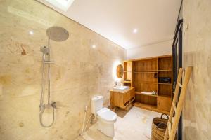 a bathroom with a shower and a toilet and a sink at Lecatica - Brand New 2BDR Paradise Villa with Expansive Pool - Your Dream Retreat in Canggu! in Seminyak +9 photos
