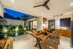 a dining room with a table and an aquarium at Lecatica - Brand New 2BDR Paradise Villa with Expansive Pool - Your Dream Retreat in Canggu! in Seminyak