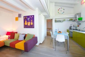 a living room with a couch and a table at Acquarius Resort Sirmione - MGH in Sirmione