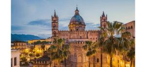 an old building with a clock tower and a cathedral at I Saraceni Cattedrale in Palermo