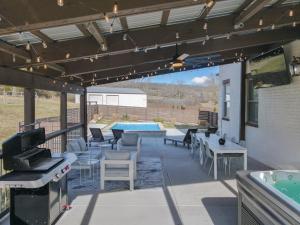a patio with a table and chairs and a pool at Music City Manor-A Grand Ole Getaway in Goodlettsville