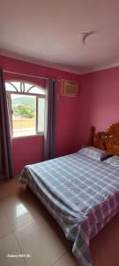 a bedroom with a bed and a window at Joinville Apartamento in Joinville