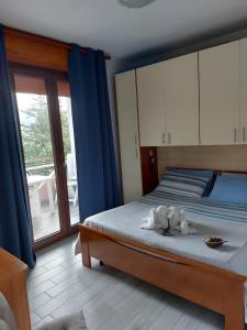 a bedroom with a bed with a stuffed animal on it at Casa Dea72 in Santa Luria