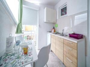 a kitchen with a counter and a sink and a counter top at Apartments Matija in Vodice