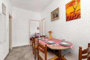 a dining room with a table and chairs at Apartment Lara in Tribunj