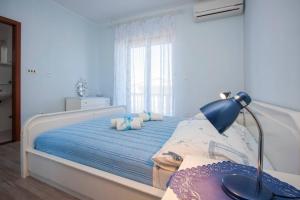 Postel nebo postele na pokoji v ubytování Family Apartments & Rooms Mikelin