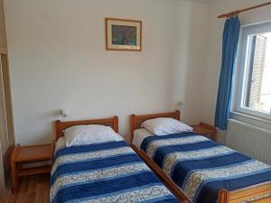 Postel nebo postele na pokoji v ubytování Apartments Pletikosa Gaj