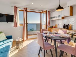 a kitchen and living room with a table and chairs at Magic Sea View - Apartments Rina in Karlobag