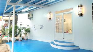 a lobby with blue floors and stairs in a building at Simple Travel in Donggang