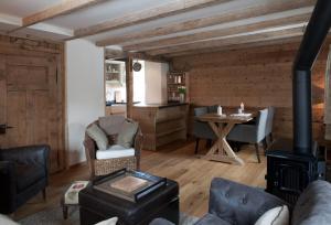 a living room with a fireplace and a table at Silverbirch Chalet - Davos in Davos