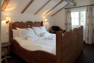 a bedroom with a large bed with stuffed animals on it at Silverbirch Chalet - Davos in Davos