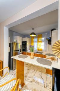 a kitchen with a large white island in a room at Appartement moderne avec piscine à Pointe-Noire in Pointe-Noire