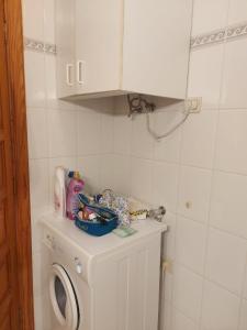 a laundry room with a washer and a washing machine at Ladybug Ocean View in Costa Del Silencio
