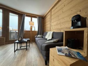 a living room with a couch and a table at Résidence Les Portes du Soleil - Propriétés Mont Amour in Avoriaz