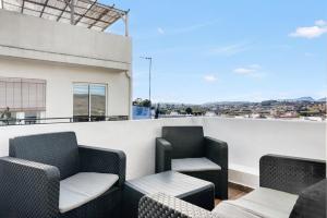 a balcony with chairs and tables on a building at Bougainvillea in Teulada