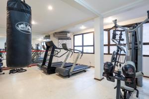 a gym with a punching bag and some tread machines at Park Tower Campinas Residence by Nacional Inn in Campinas