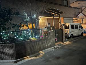 a white van parked in front of a house with lights at 烟雨轩 303 in Tokyo
